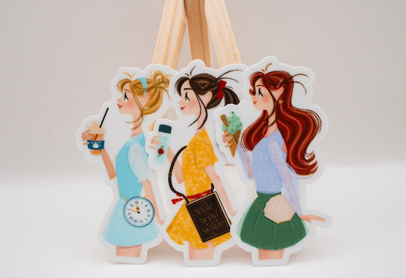 Princess Belle Disney sticker and other Disney princesses reimagined as park-goers.